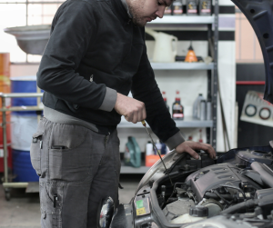 Photo of Man Inspecting Car Engine | Frederick, MD